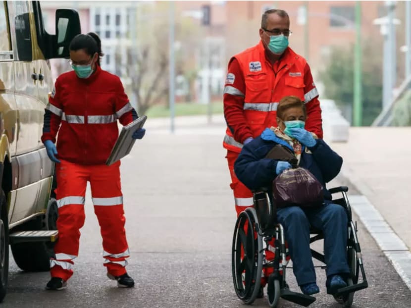 A health worker pushes a woman on a wheelchair outside the Burgos Hospital (UBU) on March 21, 2020, in Burgos, in northern Spain. A health worker pushes a woman on a wheelchair outside the Burgos Hospital (UBU) on March 21, 2020, in Burgos, in northern Spain.