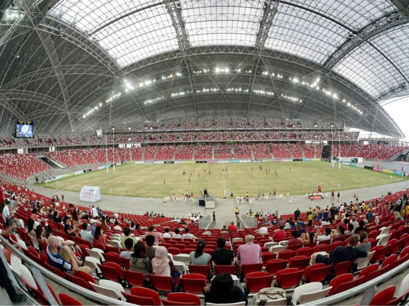 Spectators watching an international rugby tournament at the National Stadium within Singapore Sports Hub in Kallang, after it opened in June 2014.