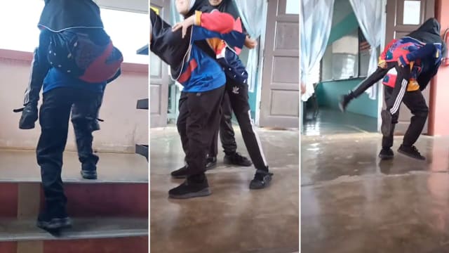马国两学生轮流背体障同学到课室 感动网民
