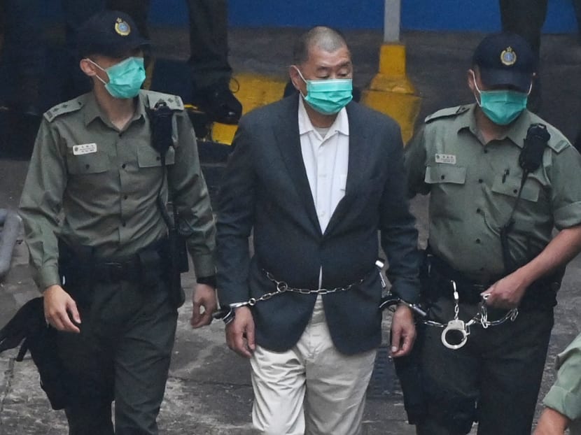 Hong Kong pro-democracy media tycoon Jimmy Lai (centre) is led into a police van as he heads to court to be charged under the territory's controversial new National Security Law in Hong Kong on Dec 12, 2020.
