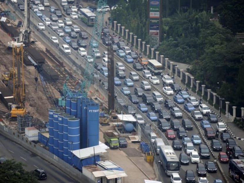 Vehicles move past the construction of a new rail line in central Jakarta. Indonesian President Joko Widodo been touring provinces in Kalimantan to survey possible locations for a new capital, The Jakarta Post reported.