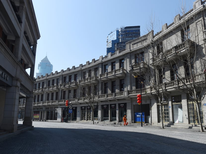 A sanitation worker cleans a street in Wuhan, the epicentre of the novel coronavirus outbreak, in China's Hubei province, on Feb 20, 2020.
