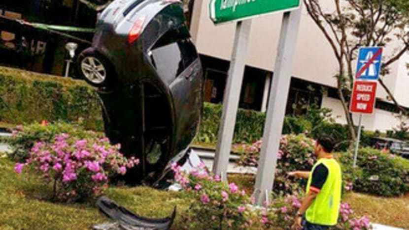 Car plunges into drain, bonnet-first