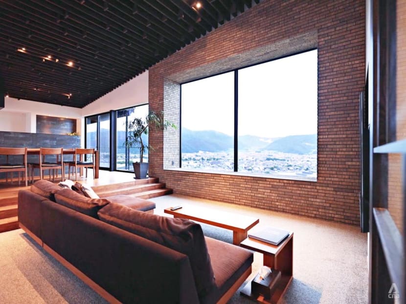 This two-building residence in Japan uses shadows and light to create a rhythm in the living spaces 