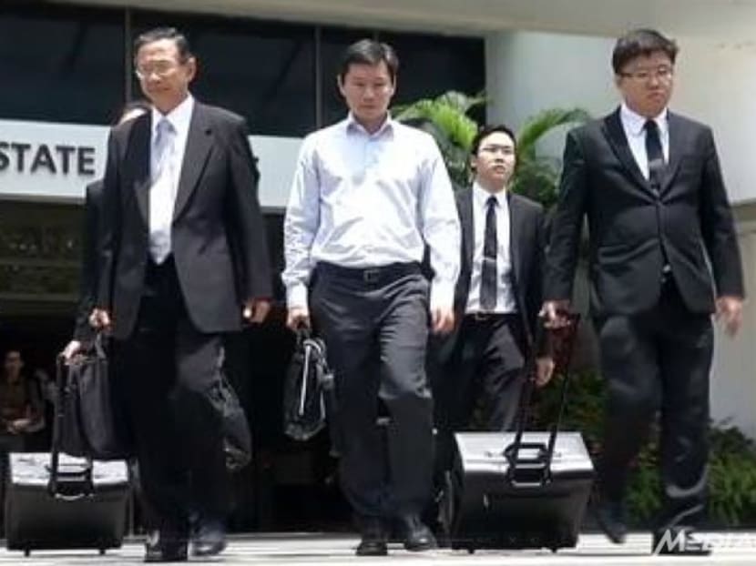 National Parks Board assistant director Bernard Lim (centre) outside the State Courts. Photo: Channel NewsAsia