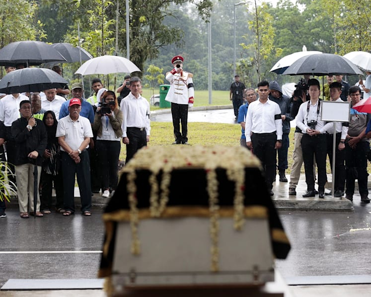 Crowds brave torrential downpour as Othman Wok is laid to rest