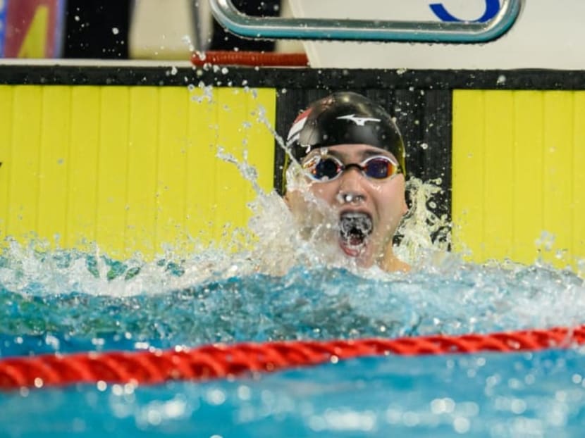 Joseph Schooling celebrates after touching home to win the 100m butterfly gold at the 31st SEA Games in Hanoi.


