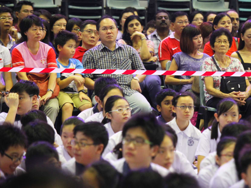 Parents waiting for PSLE results with their children. Parents are not inclined to give up on tuition for their children due to keen competition in classrooms. TODAY file photo