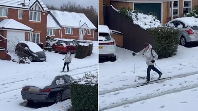 暴风雪无阻出行 英国男子踩滑雪板出门