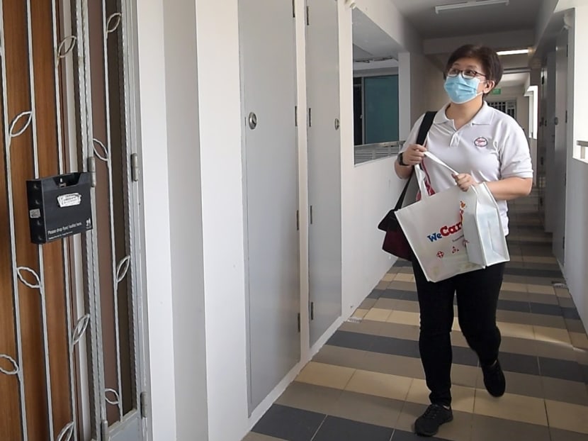 A volunteer from the People's Association delivering a care pack to a Covid-19 patient recovering at home. A volunteer from the People's Association delivering a care pack to a Covid-19 patient recovering at home.