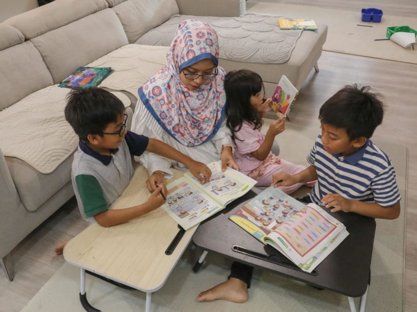 Secondary school Malay language teacher Nur Asyikin Naser reading storybooks in Malay with her children. Secondary school Malay language teacher Nur Asyikin Naser reading storybooks in Malay with her children.