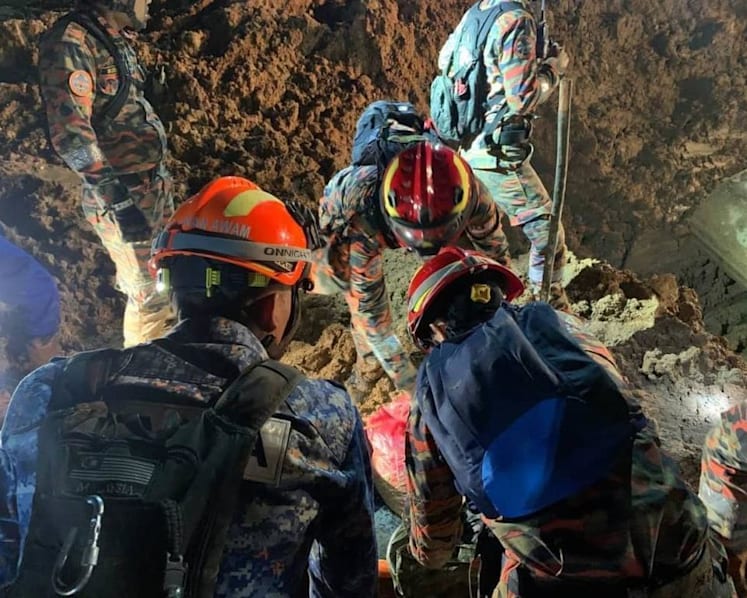 Body of man hugging dog recovered as Malaysia landslide death toll rises to 26