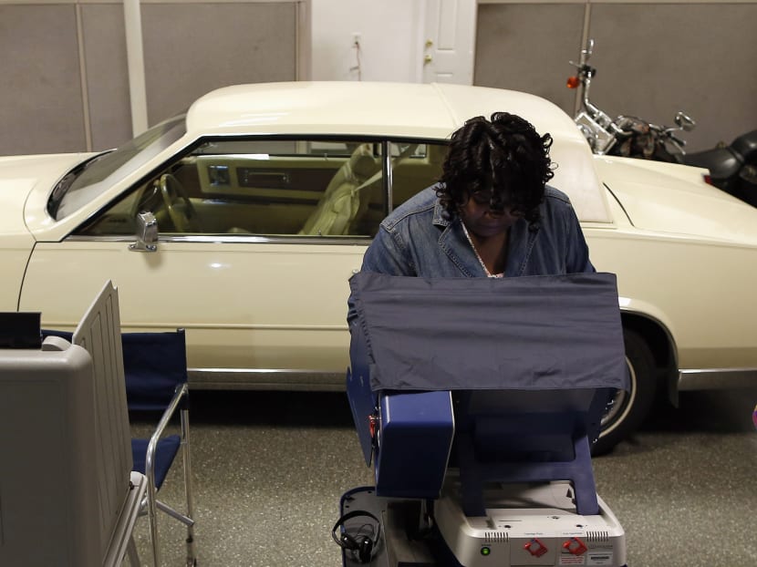A voter casts her ballot in the US midterm elections at a car dealership used as a polling station in Chicago, Illinois. Photo: Reuters