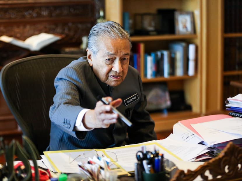 Tun Dr Mahathir Mohamad reaches for a Pilot pen during an exclusive interview with Malay Mail at the Perdana Leadership Foundation in Putrajaya. The Malaysian Prime Minister is instantly recognisable by his Nehru jackets, but what he keeps in his left breast pocket is just as much a part of his signature look.