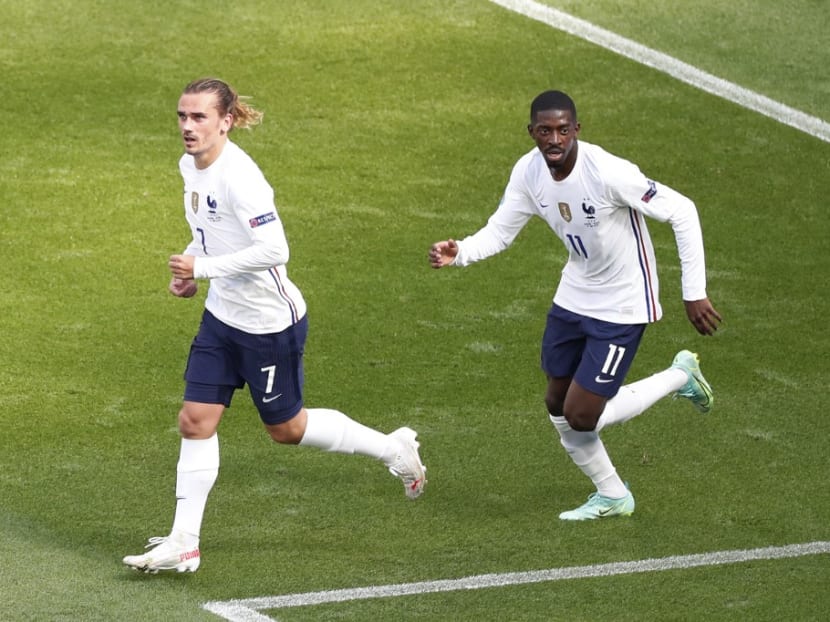 France's forward Antoine Griezmann (left) celebrates scoring his team's first goal with teammate Ousmane Dembele during the Uefa Euro 2020 Group F football match between Hungary and France at Puskas Arena in Budapest on June 19, 2021.