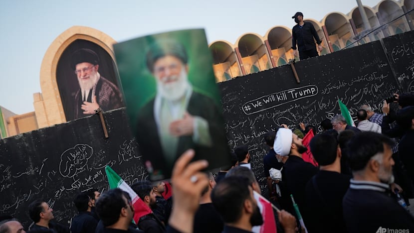 Three sons of Iran's slain leader appear at funeral, not his successor