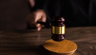 Two to be charged for instructing foreign workers to hold placards in illegal protests
