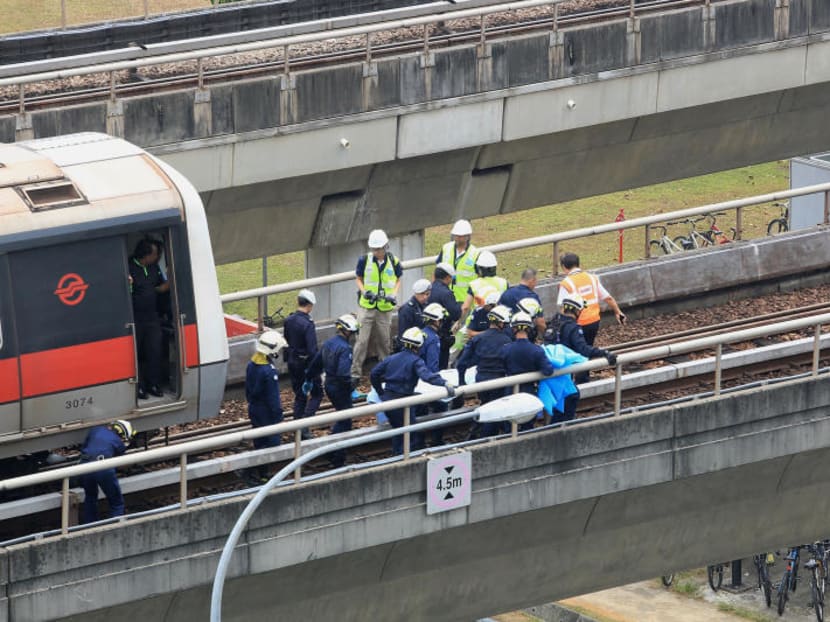 SCDF officers extricate a body on the scene of the train accident at Pasir Ris MRT station which left two SMRT staff dead. TODAY file photo SCDF officers extricate a body on the scene of the train accident at Pasir Ris MRT station which left two SMRT staff dead. TODAY file photo