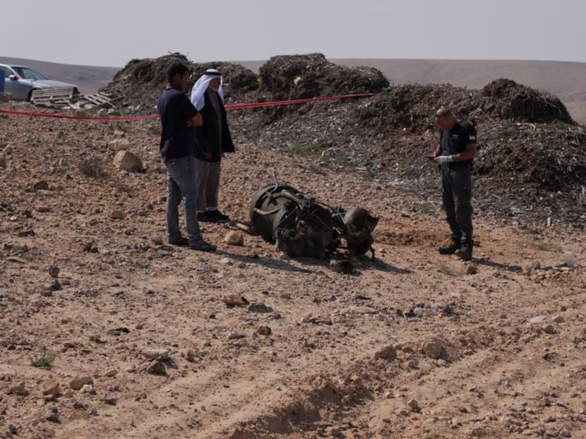 A police officer and residents inspect the remains of a rocket booster that, according to Israeli authorities critically injured a 7-year-old girl, after Iran launched drones and missiles towards Israel, near Arad, Israel, April 14, 2024. REUTERS/Christophe van der Perre A police officer and residents inspect the remains of a rocket booster that, according to Israeli authorities critically injured a 7-year-old girl, after Iran launched drones and missiles towards Israel, near Arad, Israel, April 14, 2024. REUTERS/Christophe van der Perre