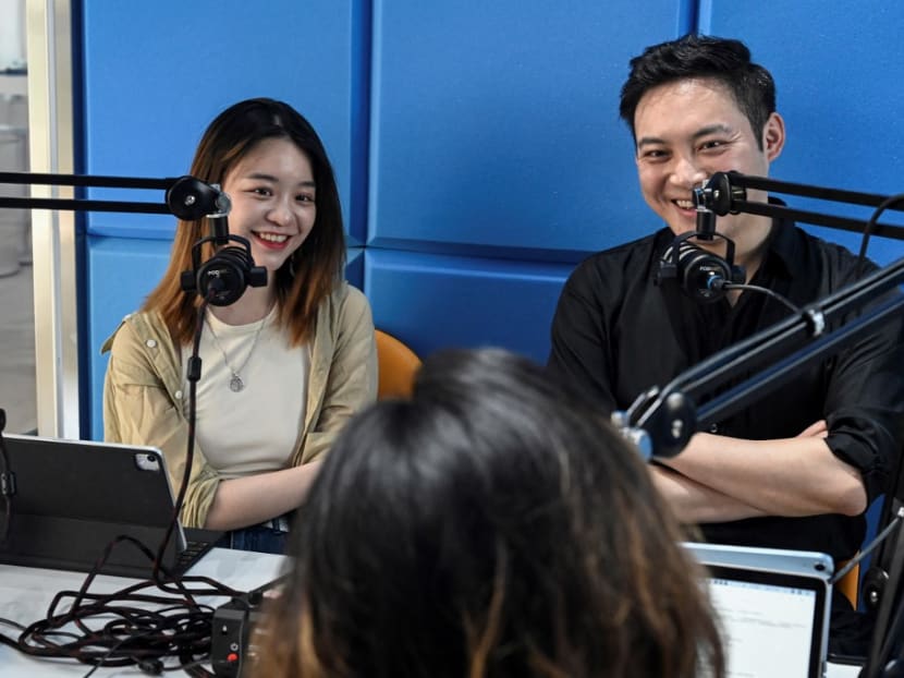 Hosts of Chinese podcast "The Weirdo" Meng Chang (right) and Xie Ruohan laughing during recording an episode in a studio in Beijing. Hosts of Chinese podcast "The Weirdo" Meng Chang (right) and Xie Ruohan laughing during recording an episode in a studio in Beijing.