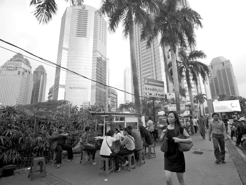 People walking in the central business district of Jakarta, Indonesia. Universities should more strongly encourage students to take up opportunities in our region. Photo: Reuters