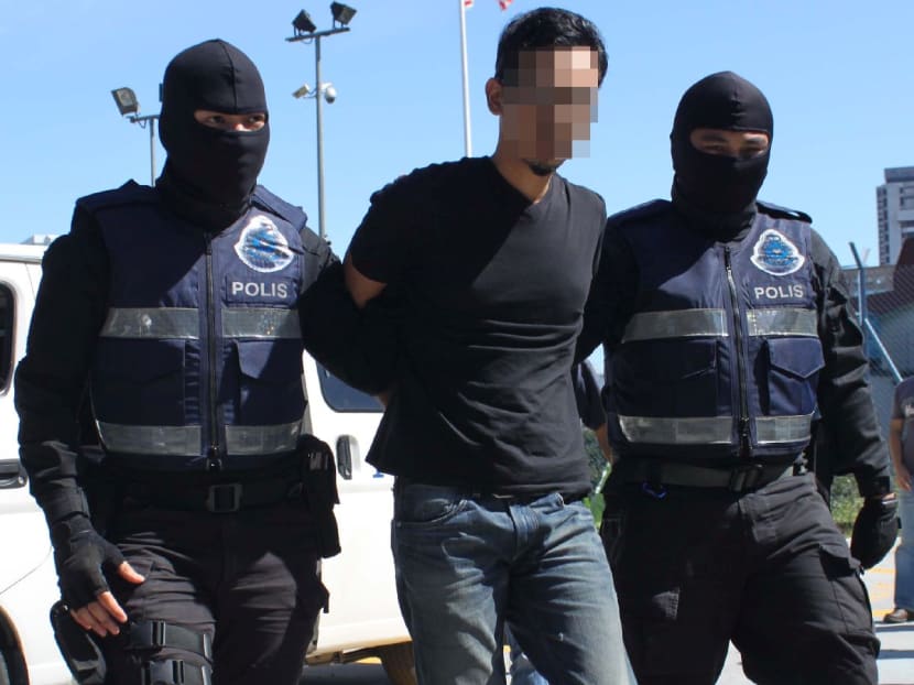 The suspect arrested in Keramat, Kuala Lumpur, for suspected links with ISIS, is seen here taken into custody by members of the police counter-terrorism unit on Jan 24, 2016. Photo: Royal Malaysian Police via The Malaysian Insider