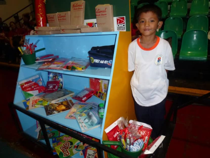 Filipino student Baby Boy Abante, 9, stands on a pushcart that serves as a mobile classroom during a ceremony for 'completers' of the pushcart classroom programme in the Manila suburb Pasig City. Photo: KYODO NEWS