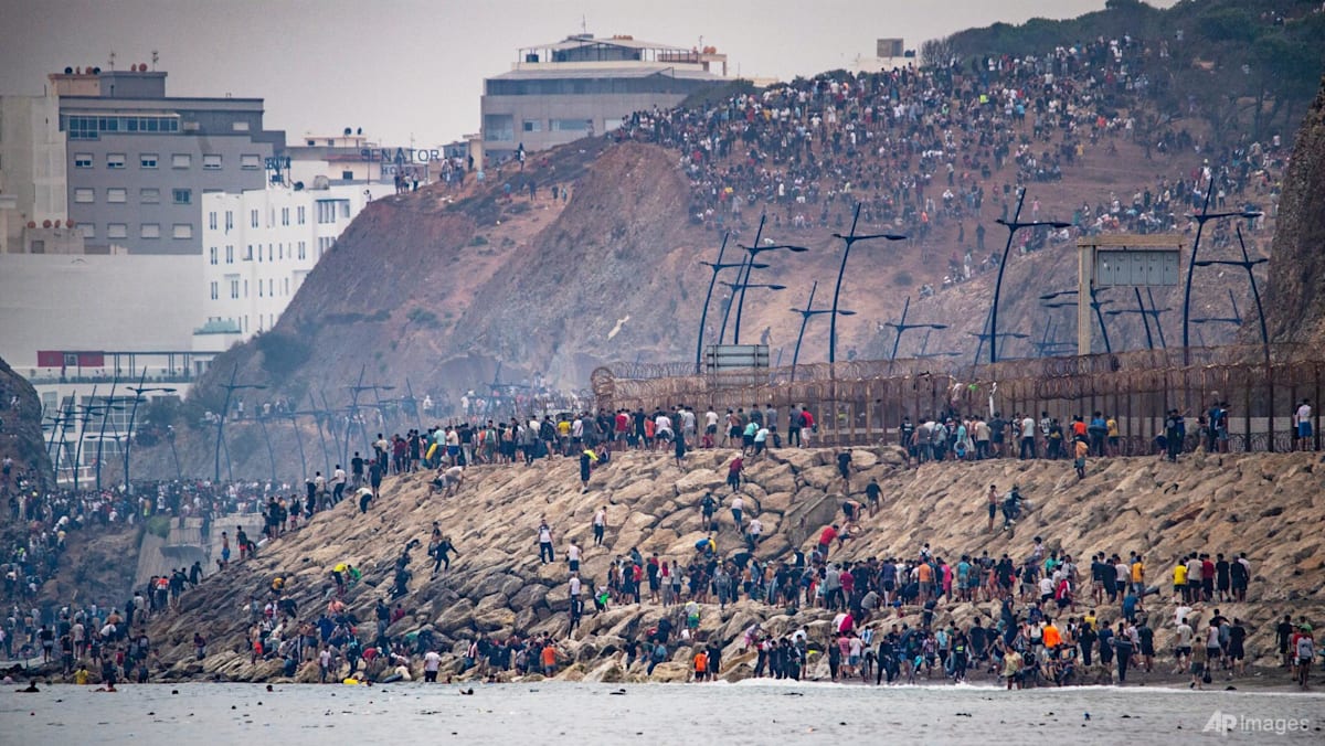 Spain says huge surge across border into enclave has reversed, half of migrants go back