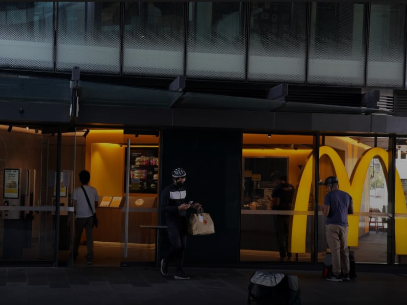 Delivery couriers practice social distancing while waiting for orders at a McDonald's open for take away following the implementation of stricter social-distancing and self-isolation rules to limit the spread of the coronavirus disease in Sydney, Australia on April 6, 2020.
