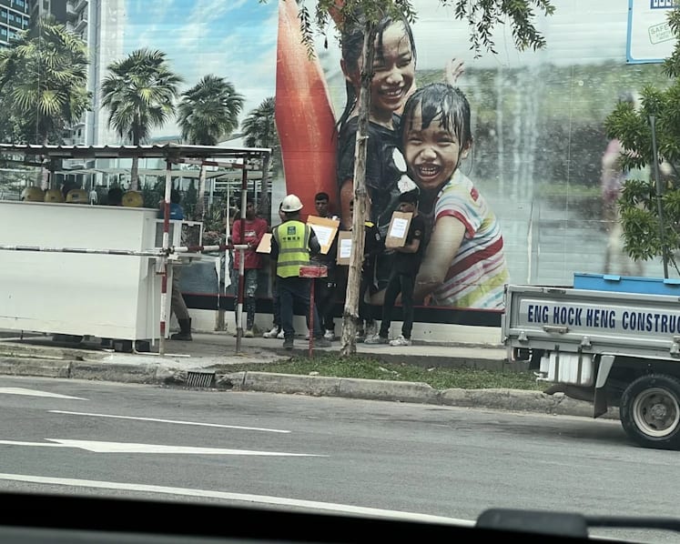 Two charged for instructing foreign workers to hold placards in illegal protests at construction site
