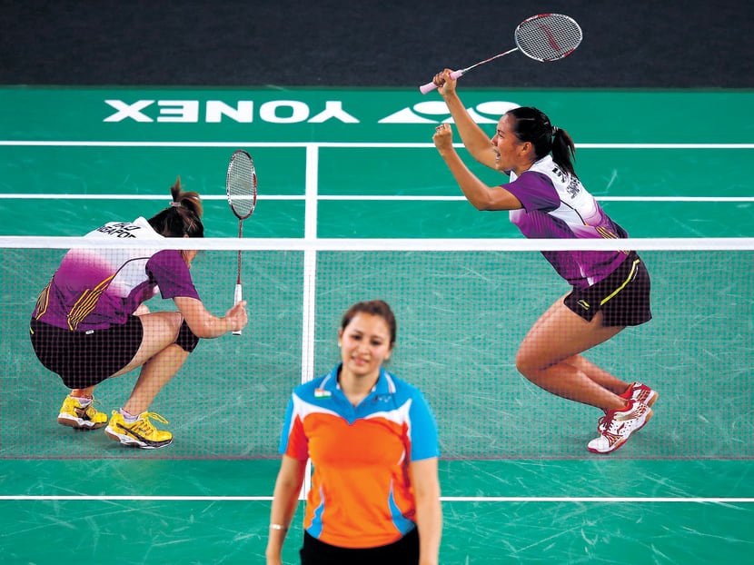 Shinta Mulia Sari and Yao Lei (top) celebrate winning the bronze in the mixed team event. Photo: GETTY IMAGES