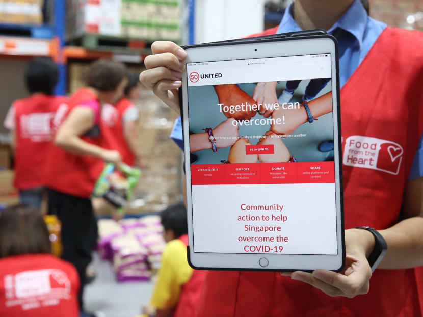 A volunteer holding up a sign at the Feb 20 launch of SG United Portal for Singaporeans looking to support community efforts in response to Covid-19.