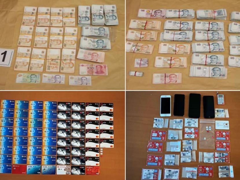 Cash, bank cards, phones and other items seized by the police in Singapore as part of a joint operation with Hong Kong police. Cash, bank cards, phones and other items seized by the police in Singapore as part of a joint operation with Hong Kong police.