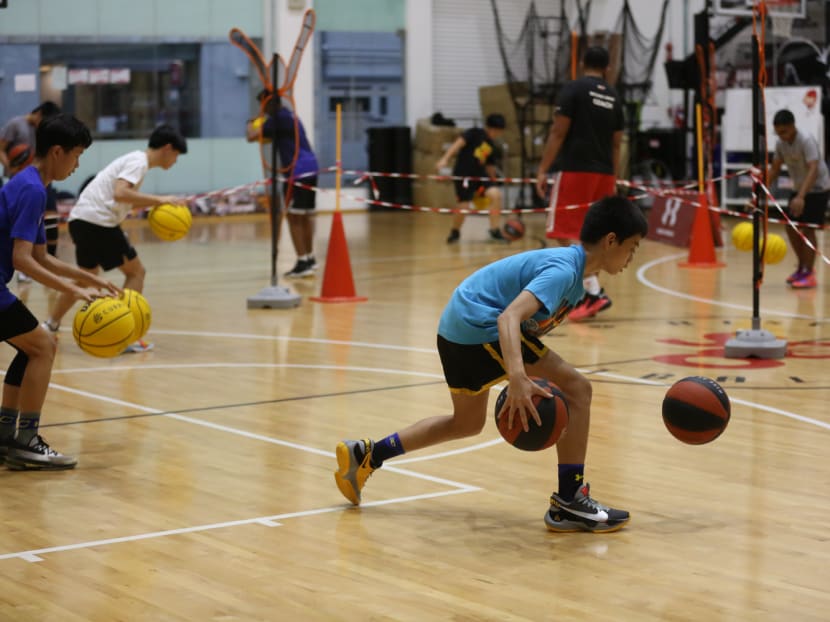 Youths are seen training at an indoor basketball court on Feb 6, 2022. Youths are seen training at an indoor basketball court on Feb 6, 2022.