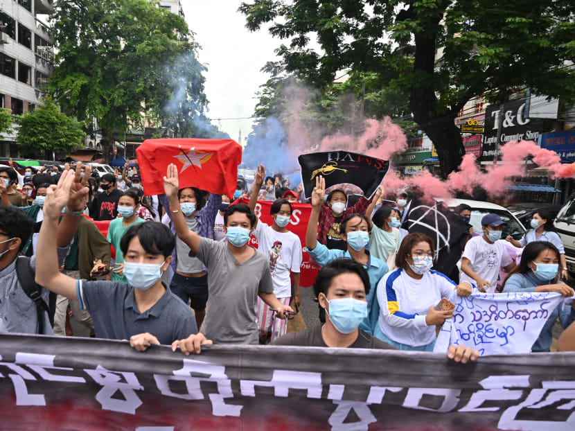 Protesters make the three-fingered salute during a demonstration against the military coup in Yangon, Myanmar on July 7, 2021.