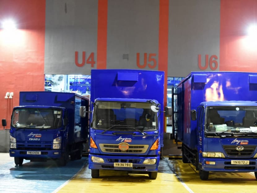 This photograph shows delivery trucks parked at a loading bay of the Singapore Post ecommerce logistics centre in Singapore. This photograph shows delivery trucks parked at a loading bay of the Singapore Post ecommerce logistics centre in Singapore.