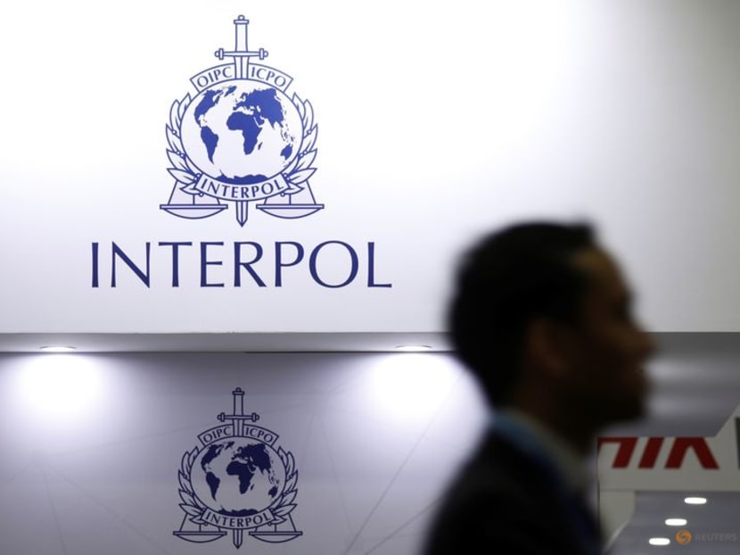 FILE PHOTO: A man passes Interpol signages at Interpol World in Singapore July 2, 2019.  REUTERS/Edgar Su/File Photo
