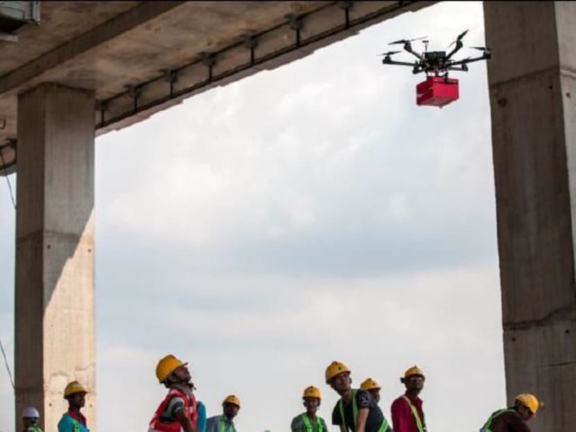 Flying drones deliver gifts to foreign workers