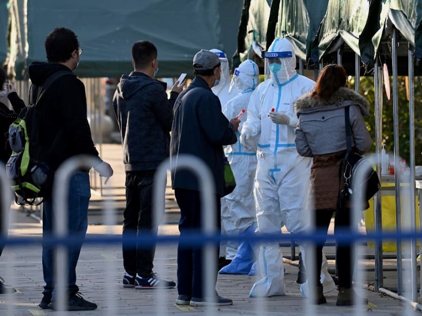 People queue for swab tests for the Covid-19 coronavirus at a nucleic acid collection station in Beijing on Oct 26, 2021.