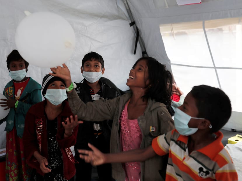Rohingya refugee children play with glove balloons at a Samaritan's Purse diphtheria clinic at Balukhali camp, near Cox's Bazar, Bangladesh. After being denied citizenship in Myanmar, an entire generation of Rohingya is now being denied the right to education.  Photo: Reuters