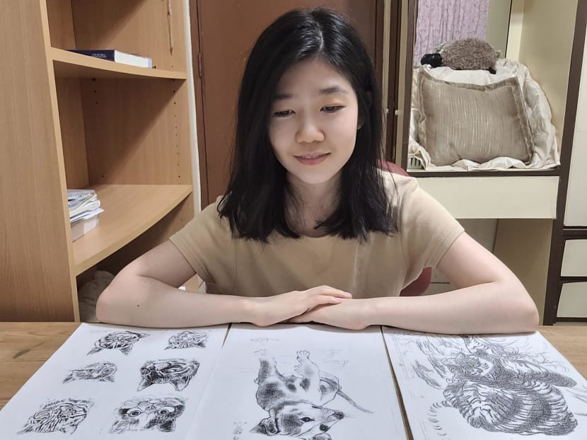 The author is seen here with photocopies of the drawings made by a janitor from her primary school which she has kept. The author is seen here with photocopies of the drawings made by a janitor from her primary school which she has kept.