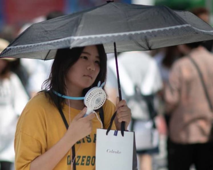 Tokyo experiments with water sprinklers to keep streets cool for Olympics