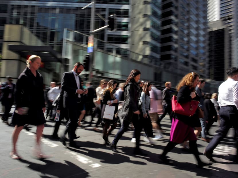 Office workers and shoppers walking through Sydney’s central business district. The Australian economy has been bolstered by an increase in government spending. PHOTO: REUTERS