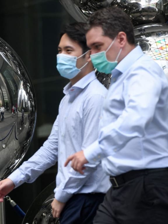 People walking past an art installation in the financial business district of Singapore.