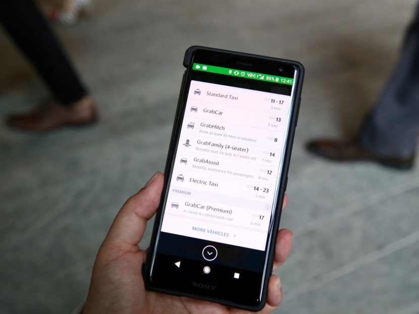 A screen on a mobile phone showing ride-hailing services and charges for taxis and private-hire cars. A screen on a mobile phone showing ride-hailing services and charges for taxis and private-hire cars.