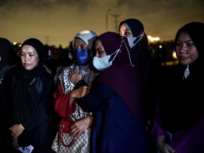 Family members attend a burial ceremony of a landslide victim at Raudhatul Sakinah cemetery in Kuala Lumpur on Dec 17, 2022.
