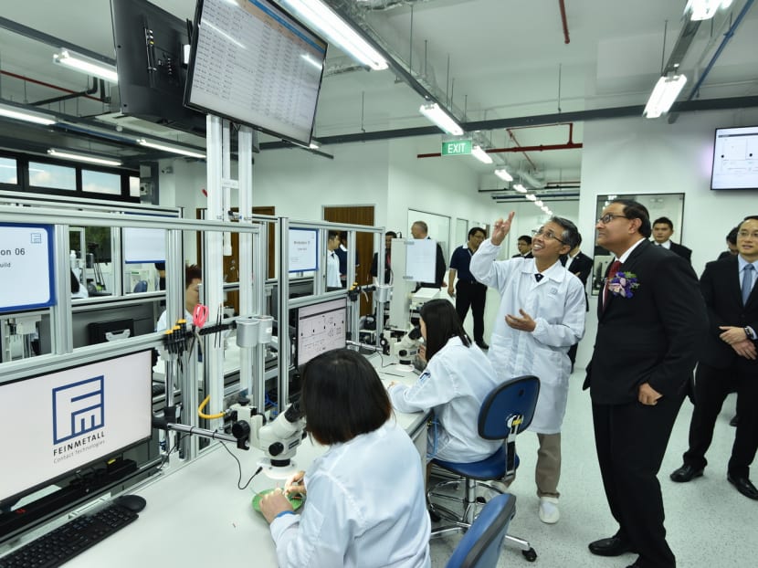 Mr Iswaran (right) during a visit to Feinmetall’s new digital manufacturing facility yesterday. The new plant incorporates a manufacturing control tower dashboard that tracks business operations for effective decision-making, and a monitoring system that provides live machine status updates. Photo: A*Star