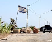 In south Lebanon, Israel flag and checkpoint mark start of occupation