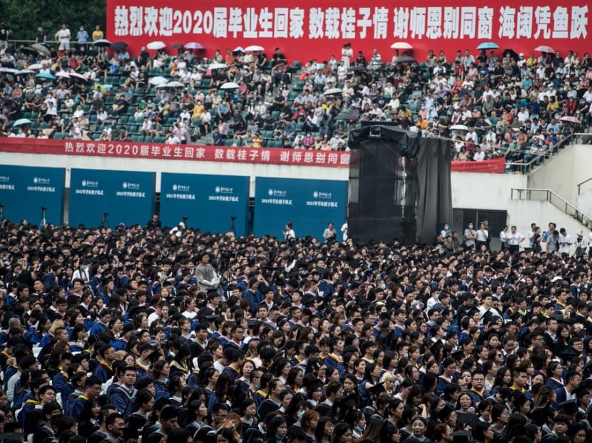 This photo taken on June 13, 2021 shows nearly 11,000 graduates, including more than 2,000 students who could not attend the graduation ceremony last year due to the Covid-19 coronavirus outbreak, attending a graduation ceremony at Central China Normal University in Wuhan, in China's central Hubei province.