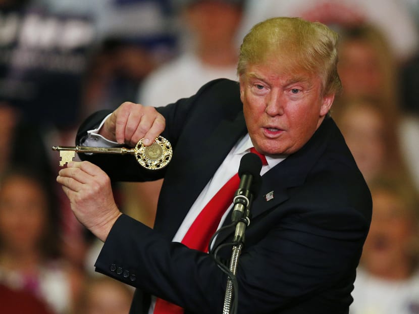 Republican presidential candidate Donald Trump holds up a key to the city he brought onto stage with him as he speaks at a campaign rally March 7, 2016, in Madison, Missouri. Photo: AP